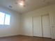 This bedroom has hardwood floors, a ceiling fan, a window, and a sliding door closet at 1905 Harvard St, North Las Vegas, NV 89030