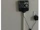View of the interior sprinkler system control panel and electrical outlet at 1905 Harvard St, North Las Vegas, NV 89030