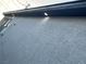 Image shows a section of the exterior wall with stucco and an outdoor light at 1905 Harvard St, North Las Vegas, NV 89030