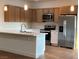 Bright kitchen featuring stainless steel appliances, light countertops and wood cabinets at 1905 Harvard St, North Las Vegas, NV 89030