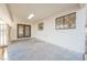 An outdoor back porch, with a gray concrete floor, a window, and a set of french doors at 1917 N Moapa Valley Blvd, Logandale, NV 89021