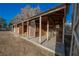 Exterior view of a rustic barn featuring a covered porch, offering potential for renovation and customization at 1917 N Moapa Valley Blvd, Logandale, NV 89021