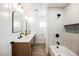 Bathroom featuring double vanity, bathtub with shower, and a neutral color scheme at 1917 N Moapa Valley Blvd, Logandale, NV 89021