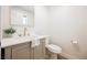 Powder room with a single vanity, gold faucet, and a neutral color scheme at 1917 N Moapa Valley Blvd, Logandale, NV 89021
