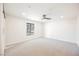 Bedroom with neutral carpet, ceiling fan, and a large window providing natural light at 1917 N Moapa Valley Blvd, Logandale, NV 89021