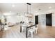 Bright open-concept dining area with contemporary lighting fixture, adjacent to the living room at 1917 N Moapa Valley Blvd, Logandale, NV 89021