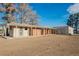 Rustic exterior featuring a long, single-story structure and weathered barn under a clear blue sky at 1917 N Moapa Valley Blvd, Logandale, NV 89021