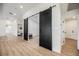 Hallway featuring black sliding barn doors and light wood flooring at 1917 N Moapa Valley Blvd, Logandale, NV 89021