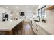 Modern kitchen featuring white cabinetry, black hardware, quartz countertops, and stainless steel appliances at 1917 N Moapa Valley Blvd, Logandale, NV 89021