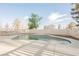 Backyard pool surrounded by concrete decking and a white privacy fence at 1917 N Moapa Valley Blvd, Logandale, NV 89021