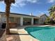 Private backyard pool with a covered patio and solar panels on the roof at 2267 Muir Ct, Henderson, NV 89052