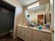 Bathroom featuring a double vanity, large mirror, and open doorway to a shower at 2267 Muir Ct, Henderson, NV 89052