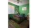 Green bedroom with a ceiling fan, a window with blinds, and wood-look floors at 2267 Muir Ct, Henderson, NV 89052