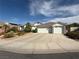 Charming single-story home featuring a spacious driveway and a meticulously maintained desert landscape at 2267 Muir Ct, Henderson, NV 89052
