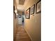 Hallway with wood-look floors and picture frame molding displaying artwork at 2267 Muir Ct, Henderson, NV 89052