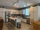 Bright and airy kitchen boasts white cabinets, stainless steel appliances, and a functional center island at 2267 Muir Ct, Henderson, NV 89052