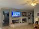 Open-concept living room featuring tile flooring, recessed lighting, and a cozy fireplace with custom built-ins at 2267 Muir Ct, Henderson, NV 89052