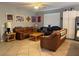 Comfortable living room with tile flooring, a ceiling fan, and ample seating for Gathering and guests at 2267 Muir Ct, Henderson, NV 89052