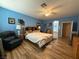 Serene main bedroom bathed in natural light, features a ceiling fan and wood-look flooring at 2267 Muir Ct, Henderson, NV 89052