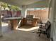 Covered outdoor kitchen with built-in grill, counter space, and refrigerator, great for outdoor dining at 2267 Muir Ct, Henderson, NV 89052
