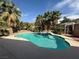 Sparkling in-ground pool surrounded by mature landscaping and palm trees at 2267 Muir Ct, Henderson, NV 89052