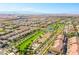 This aerial shot shows community tennis courts, a green space and the surrounding neighborhood at 2369 Via Barranca St, Henderson, NV 89044