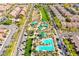 An aerial view shows a community pool, playground, basketball court and common green area at 2369 Via Barranca St, Henderson, NV 89044