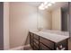 A powder bathroom features a granite countertop, dark cabinets, and vanity mirror at 2369 Via Barranca St, Henderson, NV 89044