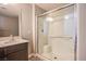 Bathroom featuring glass-enclosed shower, modern fixtures and marble countertop at 2369 Via Barranca St, Henderson, NV 89044