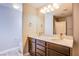 Bathroom with double sink vanity, marble countertops, and wood cabinets at 2369 Via Barranca St, Henderson, NV 89044