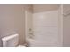 A tiled bathroom features a shower-tub combo with white tile and a toilet at 2369 Via Barranca St, Henderson, NV 89044