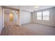 Bedroom with neutral carpet, ceiling fan, and natural light from two large windows at 2369 Via Barranca St, Henderson, NV 89044