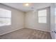 A carpeted bedroom features neutral paint, multiple windows, and a closet door providing great light at 2369 Via Barranca St, Henderson, NV 89044