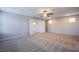 Large bedroom with neutral carpet, ceiling fan, and ample natural light at 2369 Via Barranca St, Henderson, NV 89044
