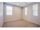 A bedroom features three windows, neutral paint, and carpet providing a bright and welcoming atmosphere at 2369 Via Barranca St, Henderson, NV 89044