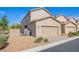 A two-story home with a two-car garage, desert landscaping, and a paved driveway at 2369 Via Barranca St, Henderson, NV 89044