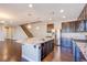 Open concept kitchen with a large island and stainless steel appliances at 2369 Via Barranca St, Henderson, NV 89044