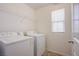 A laundry room features a washer, dryer, and wire shelving at 2369 Via Barranca St, Henderson, NV 89044