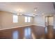 Open living room with hardwood floors and large windows at 2369 Via Barranca St, Henderson, NV 89044