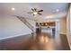 Hardwood floor living room that opens to kitchen with island, stairs nearby at 2369 Via Barranca St, Henderson, NV 89044
