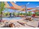 Neighborhood playground shaded with colorful sails, with swings, slides and benches for everyone's enjoyment at 2369 Via Barranca St, Henderson, NV 89044