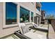 Backyard patio with comfortable lounge chairs, lush landscaping, and view of the home, perfect for relaxation at 2750 Evolutionary Ln, Las Vegas, NV 89138