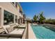 Relaxing backyard featuring a well-maintained pool, comfortable lounge chairs, and a BBQ area for outdoor gatherings at 2750 Evolutionary Ln, Las Vegas, NV 89138