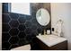 Contemporary bathroom featuring sleek black tile, white countertop, and modern gold fixtures at 2750 Evolutionary Ln, Las Vegas, NV 89138