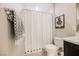 Compact bathroom showing the toilet and shower behind a curtain with a neutral color scheme and modern fixtures at 2750 Evolutionary Ln, Las Vegas, NV 89138