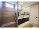 A stunning bathroom with a sleek double vanity, a glass-enclosed shower with a built-in bench, and modern fixtures at 2750 Evolutionary Ln, Las Vegas, NV 89138
