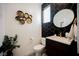 Stylish powder room features black geometric tile, modern fixtures, and decorative brass accents at 2750 Evolutionary Ln, Las Vegas, NV 89138
