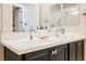 Modern bathroom featuring dual sinks, chrome faucets, and dark cabinets with a large mirror at 2750 Evolutionary Ln, Las Vegas, NV 89138