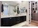 Bathroom features double sinks, under sink cabinets, a large mirror, and access to the walk in closet at 2750 Evolutionary Ln, Las Vegas, NV 89138