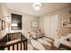 Cozy Bedroom featuring a crib, chair, changing table and patterned rug at 2750 Evolutionary Ln, Las Vegas, NV 89138